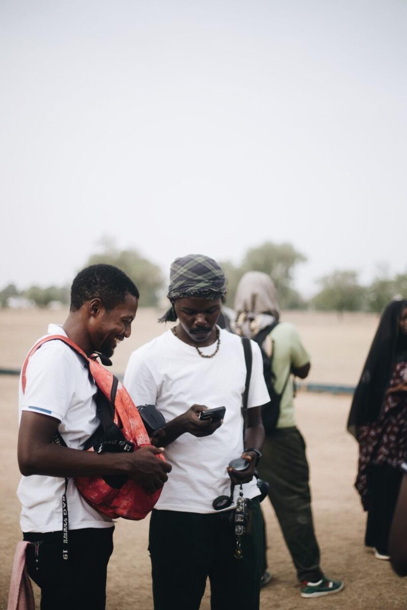  Community members using a shared internet access point or community WiFi kiosk in a 
rural Nigerian village setting