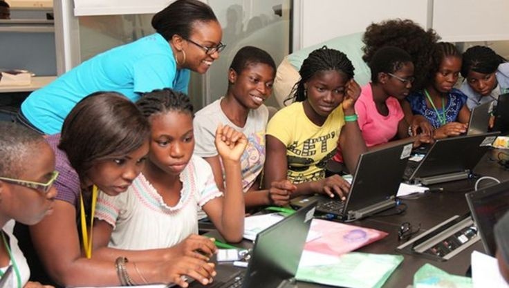  Nigerian girls engaged in a coding lesson on laptops at a community technology centre 